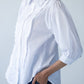 Claire frill shirt, side view showing puff sleeve and red thread on last button