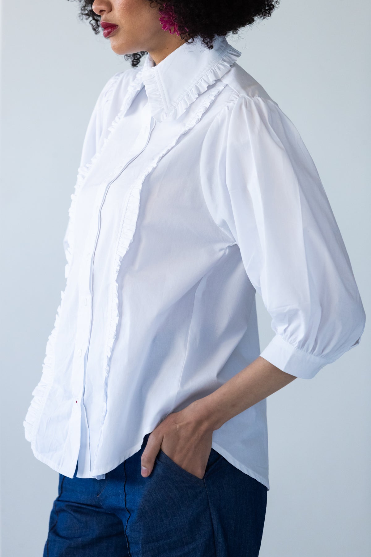 Claire frill shirt, side view showing puff sleeve and red thread on last button