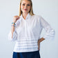 Serafina white pintuck shirt, front view with hand at collar