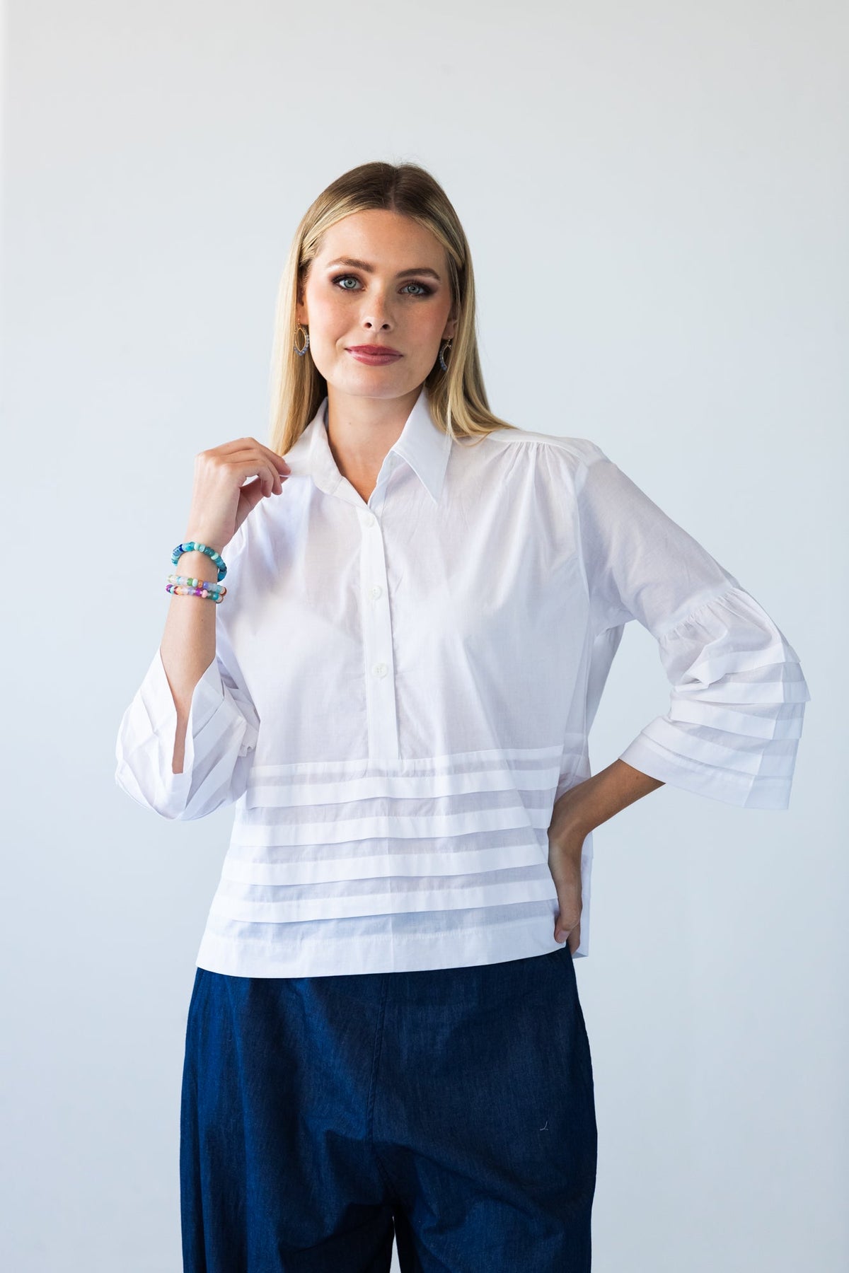 Serafina white pintuck shirt, front view with hand at collar