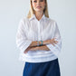 Serafina white pintuck shirt, front view with arms crossed