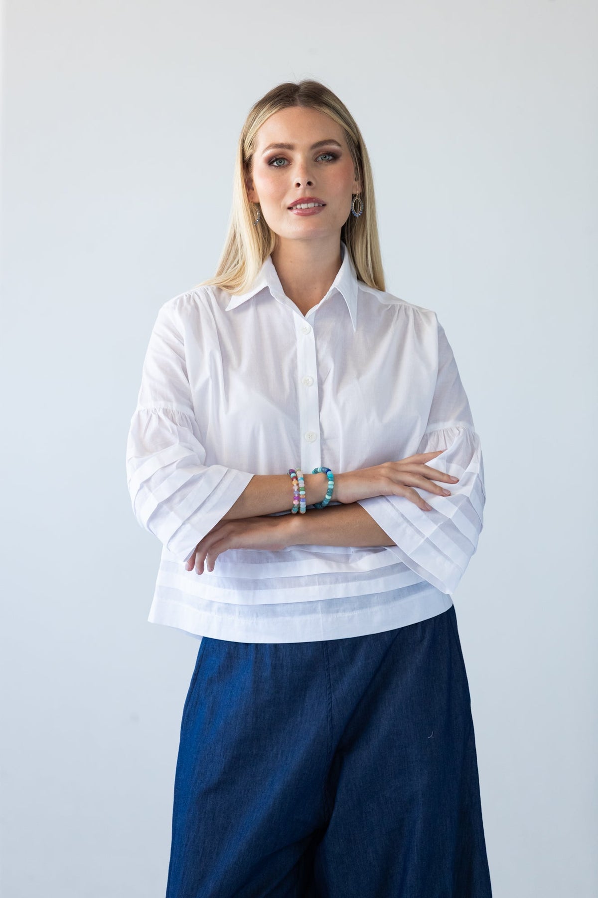 Serafina white pintuck shirt, front view with arms crossed