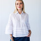Serafina white pintuck shirt, front view close up looking to the side