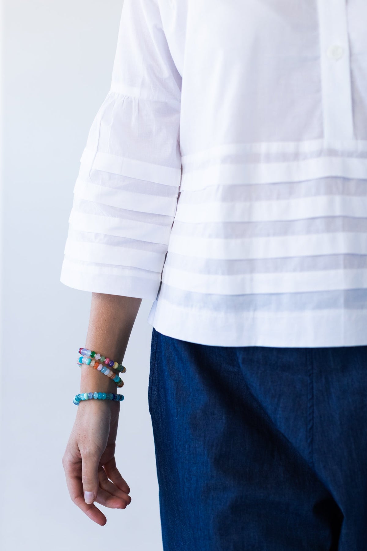Serafina white pintuck shirt, close up of hem pintuck band and sleeve cuff