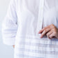 Serafina white pintuck shirt, close up of collar, placket and hem pintuck band