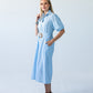 Harlow blue and white stripe shirt dress, side view with hand in pockets