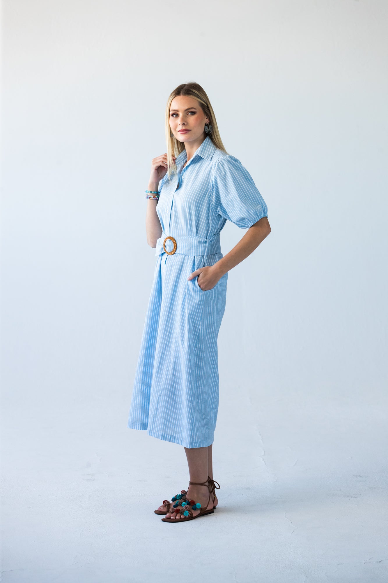 Harlow blue and white stripe shirt dress, side view with hand in pockets