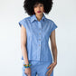 Reese blue and white stripe shirt, front view with printed bag and bracelets