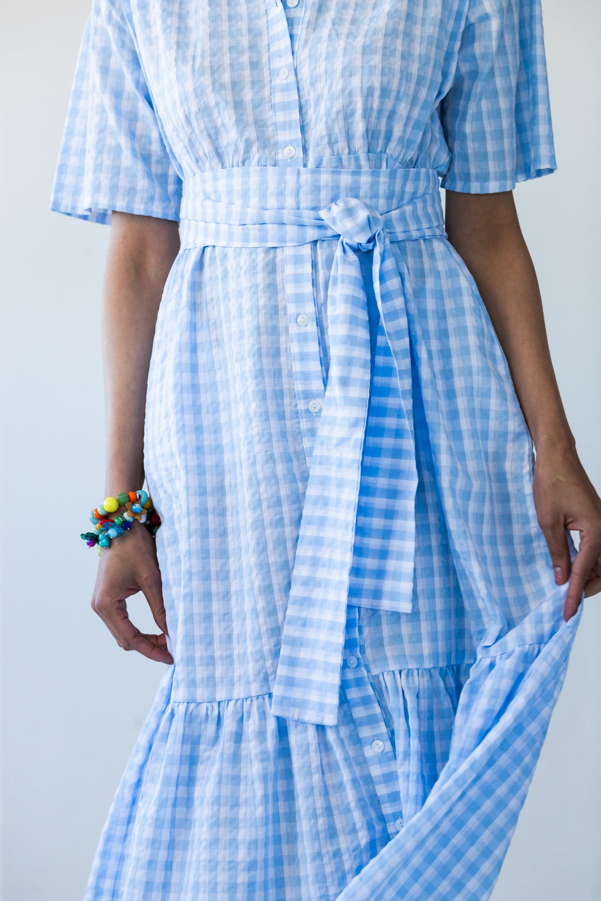 Frankie blue check dress, close-up of tied belt and tiered hem
