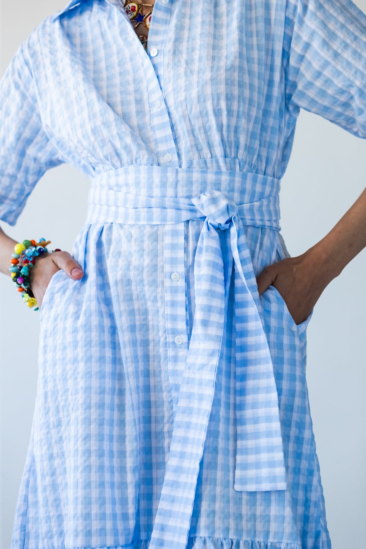 Frankie blue check dress, close-up front view with hands in pockets