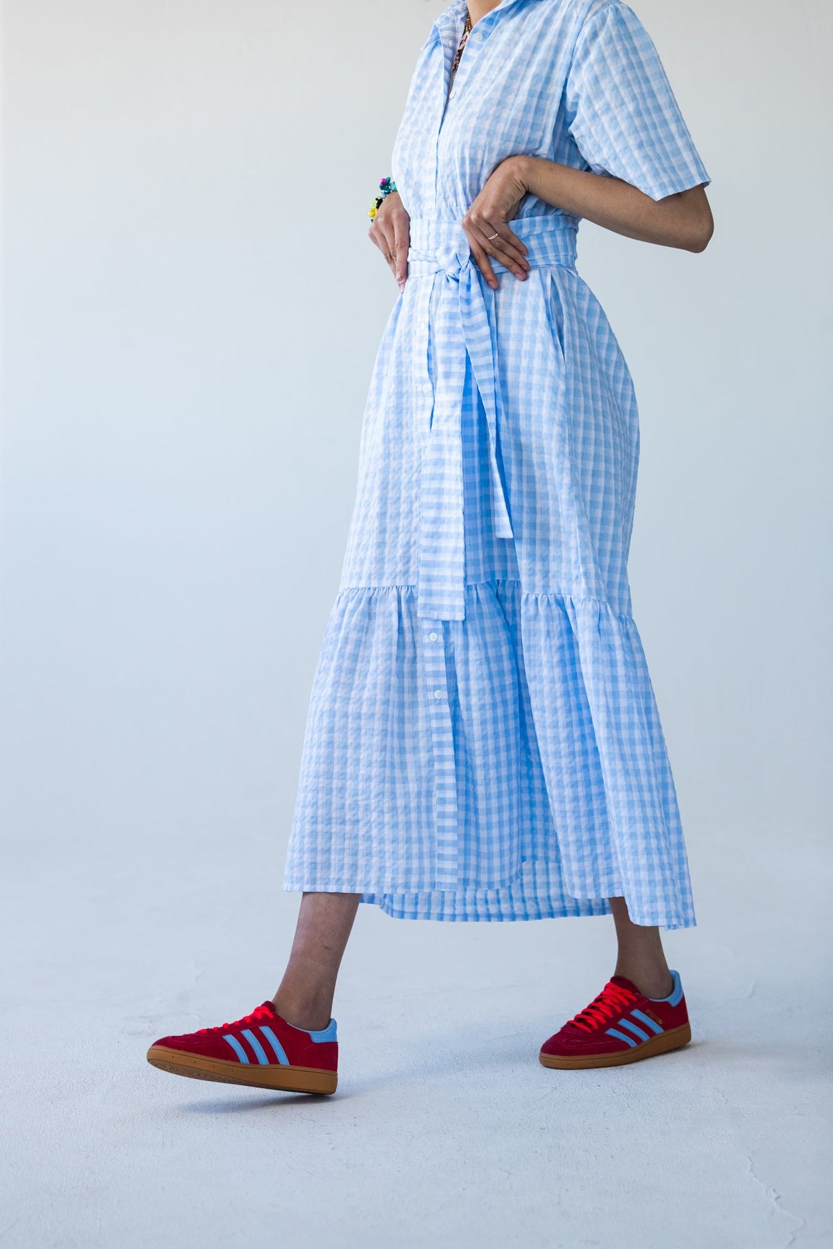 Frankie blue check dress, side view walking showing tiered hem