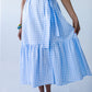 Frankie blue check dress, front view holding skirt to show tiered hem