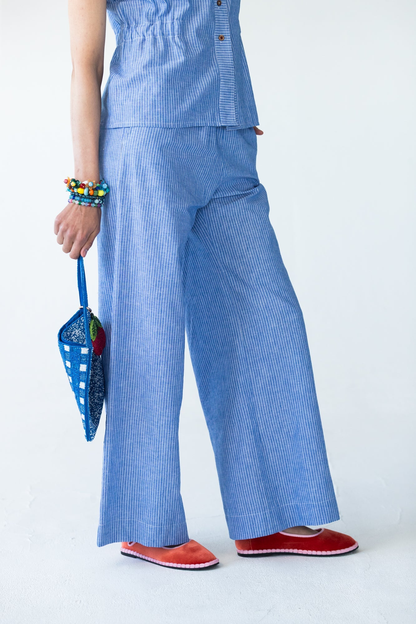 Sydney wide leg stripe pants, close up front view with beaded bag