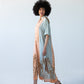 Bailey peach and pale blue symmetrical stripe kaftan, side  view showing palm print hem and side slit