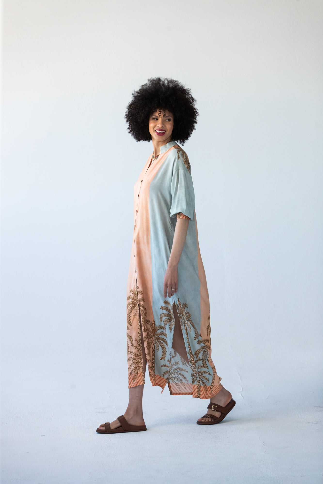 Bailey peach and pale blue symmetrical stripe kaftan, side  view showing palm print hem and side slit