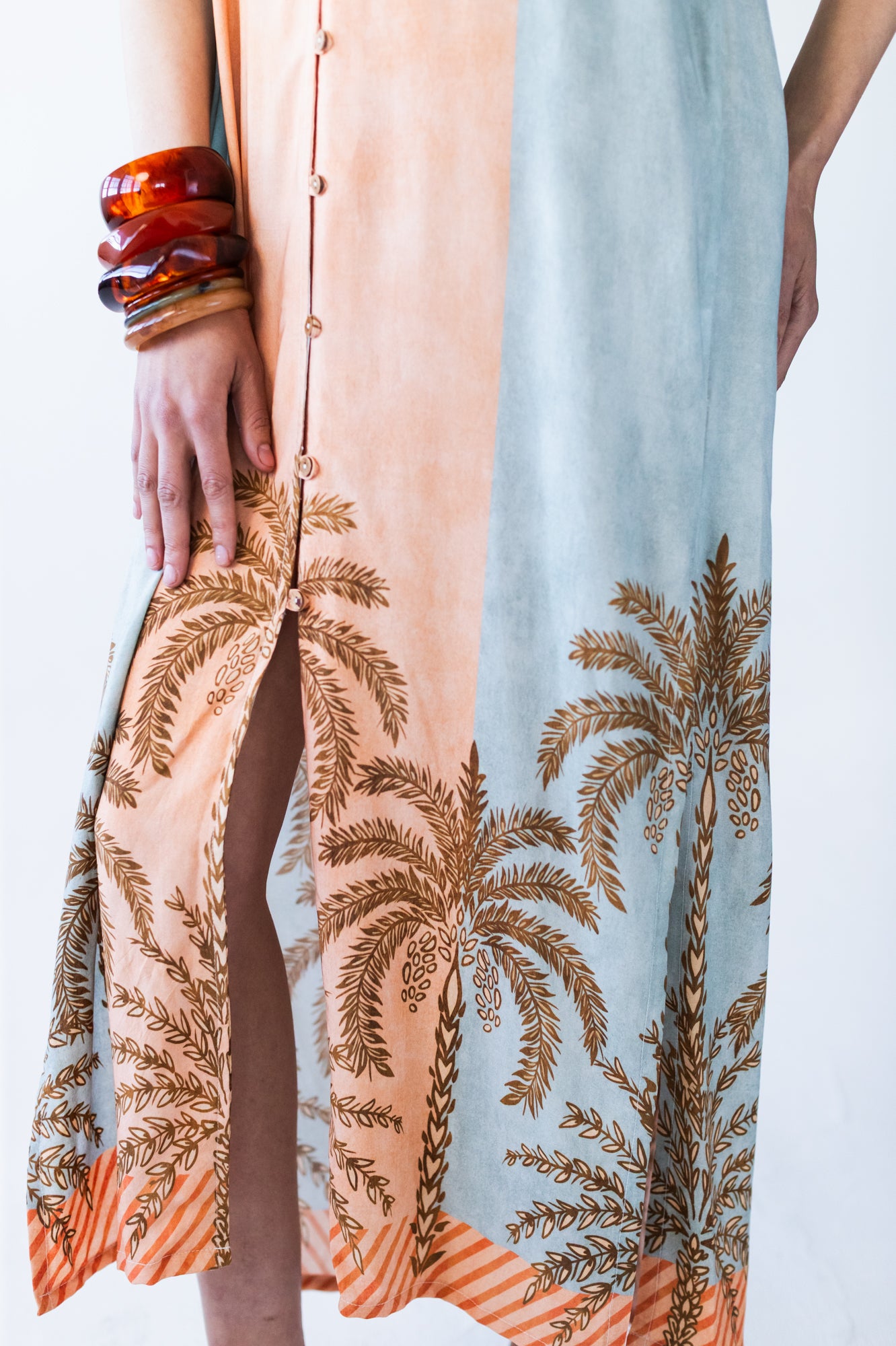 Bailey kaftan, close up of front slit and palm print hem detail