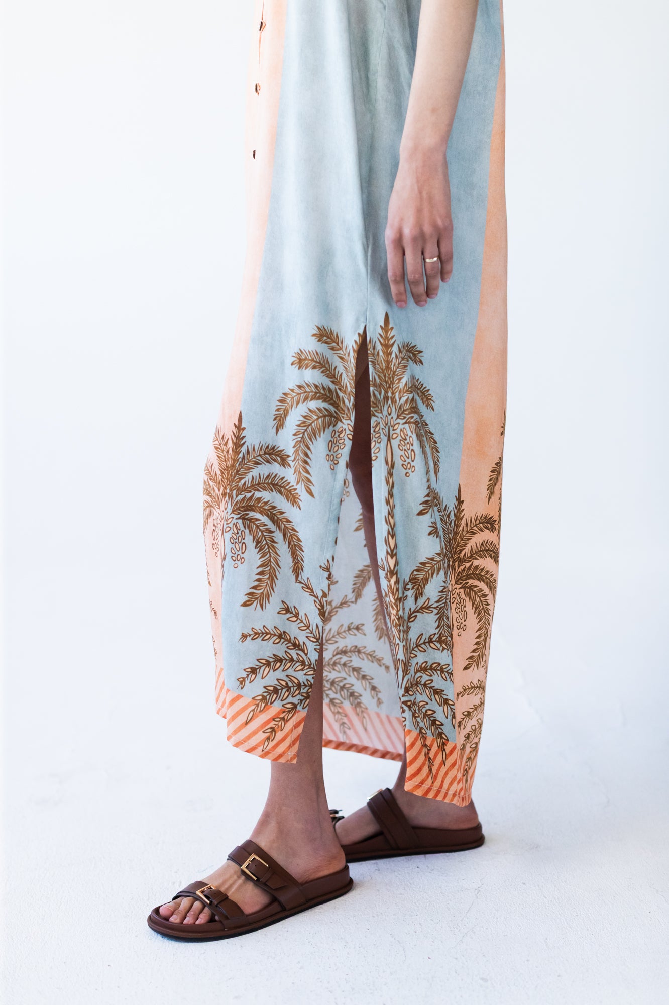 Bailey kaftan, close up of side slit and palm print hem detail