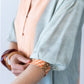 Bailey kaftan, close up of gauged cuff with button and loop closure