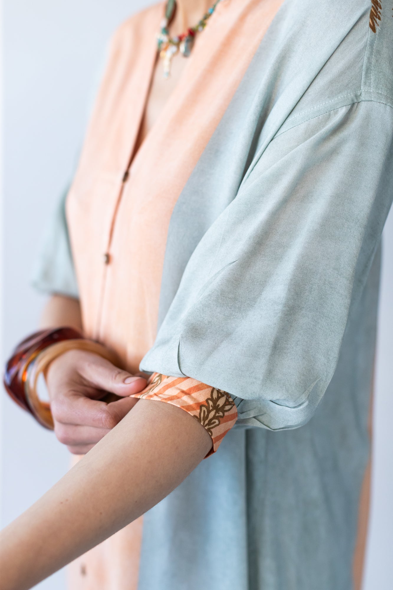 Bailey kaftan, close up of gauged cuff with button and loop closure