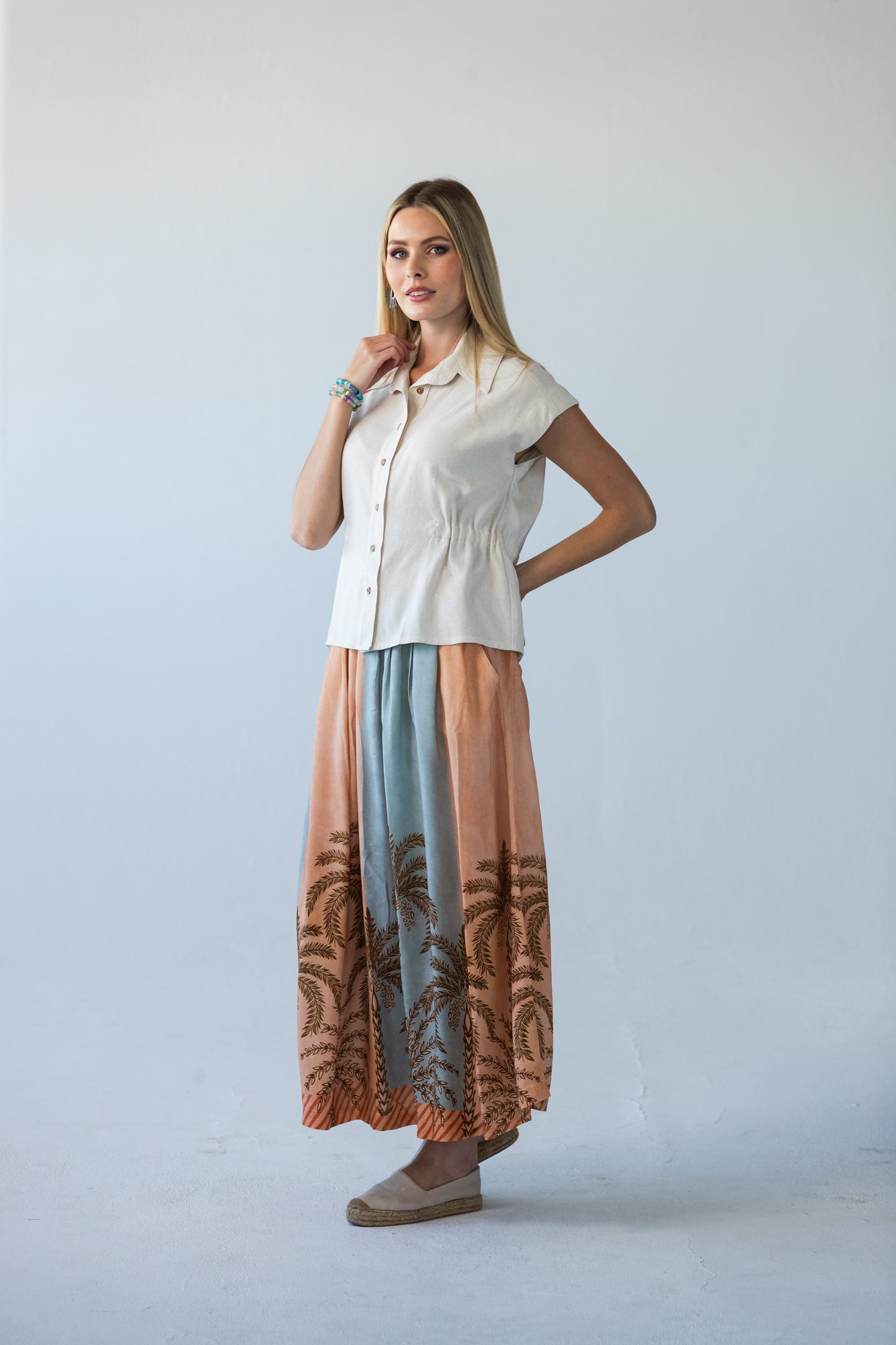 Sorrento stripe palm print skirt, front view with hand at collar