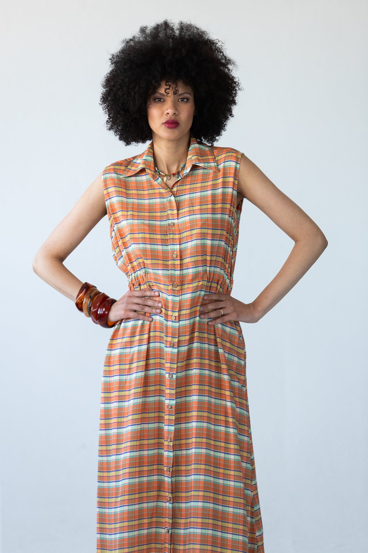 Sutton orange check shirt-dress, front view with hands on hips at the elasticated waist