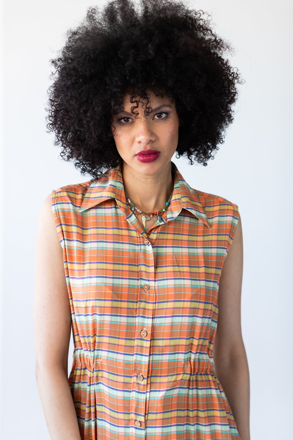 Sutton orange check shirt-dress, front view showing collar and button placket