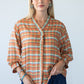 Darcy orange check frill shirt, front view styled with denim balloon pants
