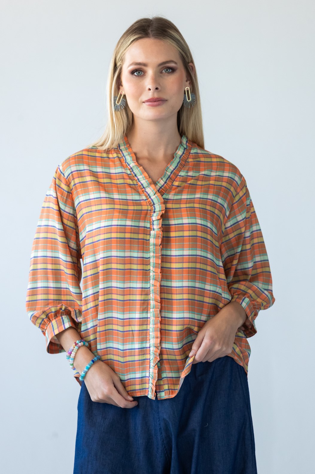 Darcy orange check frill shirt, front view styled with denim balloon pants