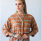 Darcy frill shirt, front view with hands clasped showing frilled V-neck and placket