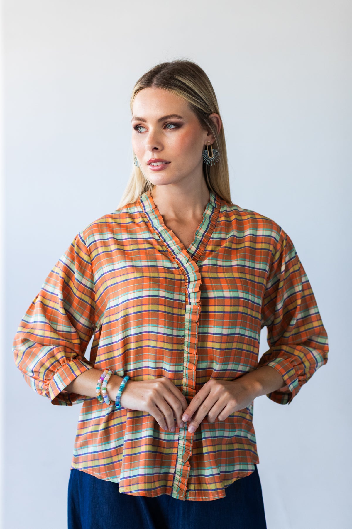 Darcy frill shirt, front view with hands clasped showing frilled V-neck and placket