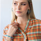 Darcy frill shirt, close-up of frilled V-neck with hand at collar