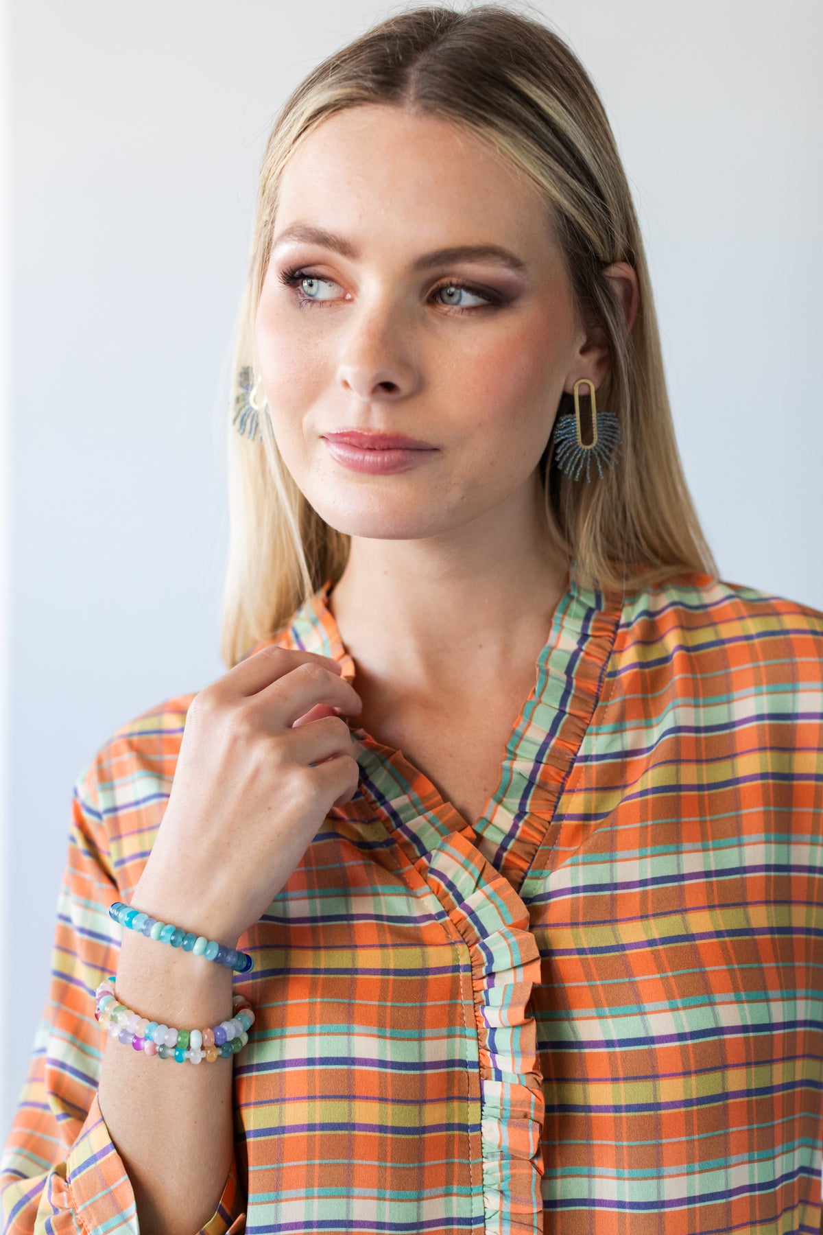 Darcy frill shirt, close-up of frilled V-neck with hand at collar