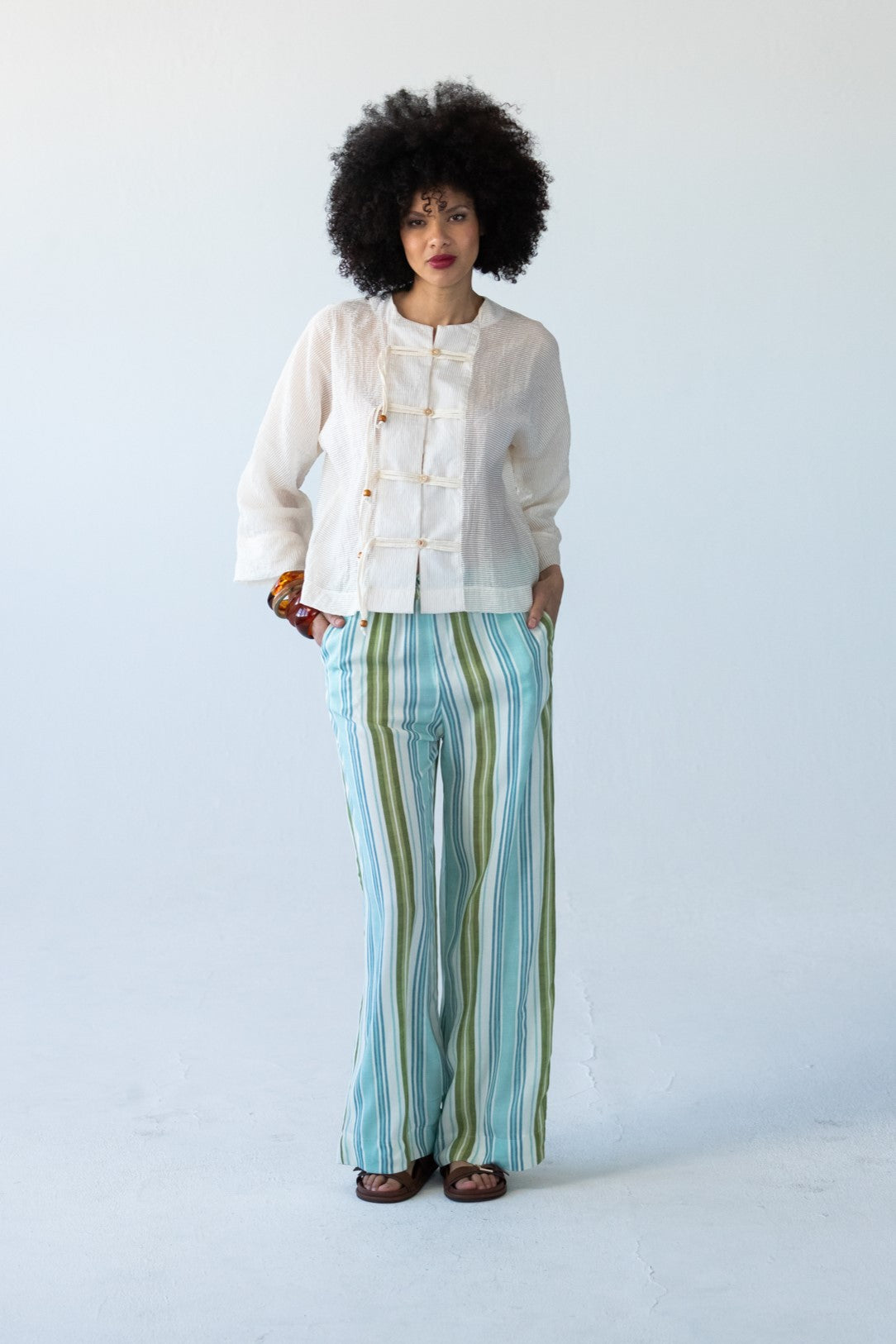 Sydney blue and green stripe wide leg pants, front view styled with cream jacket