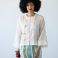 Amelia milk relaxed shirt, close up front view styled with Sydney pants in blue and green stripe