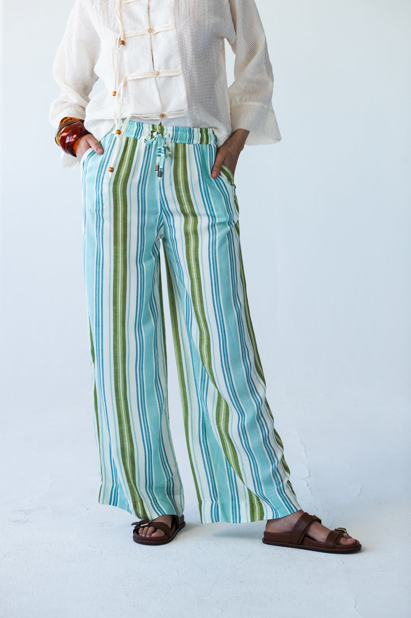 Sydney stripe wide leg pants, close up front view with hands in pockets