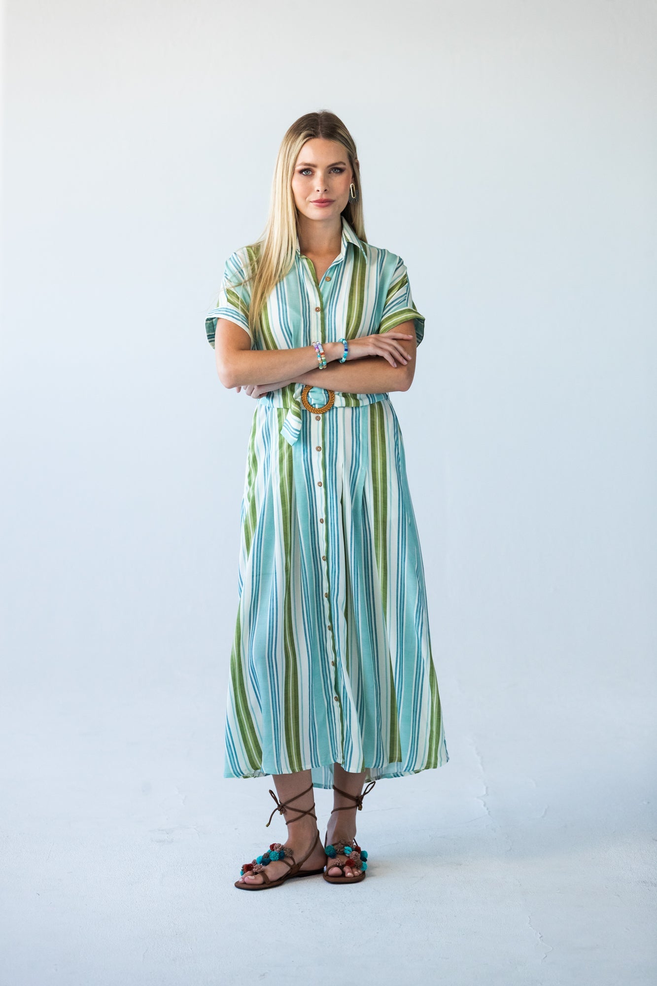 Quinn blue green stripe dress, front view with arms crossed
