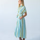 Quinn blue green stripe dress, side profile view with hand in pocket