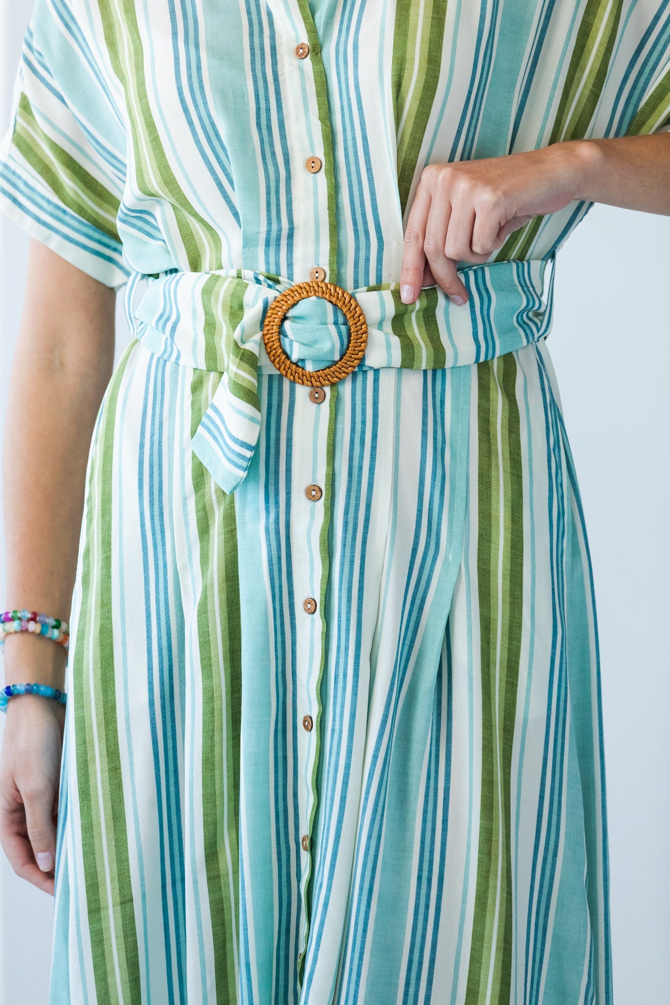 Quinn blue green stripe dress, close up of belt buckle and button placket