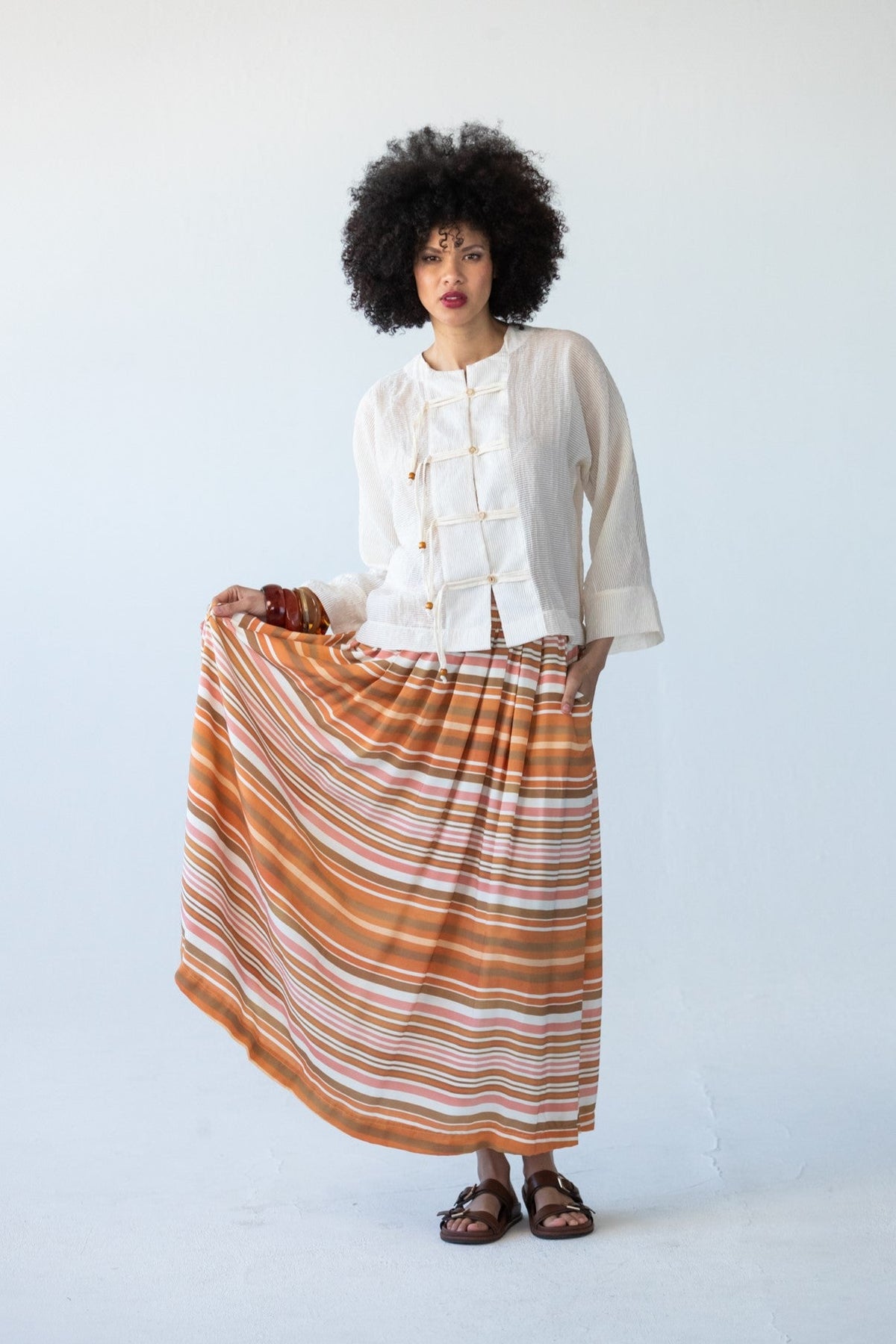 Sorrento Sunset Stripe maxi skirt, front view holding fabric to show stripe