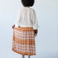 Sorrento Sunset Stripe skirt, back view holding fabric to show stripe