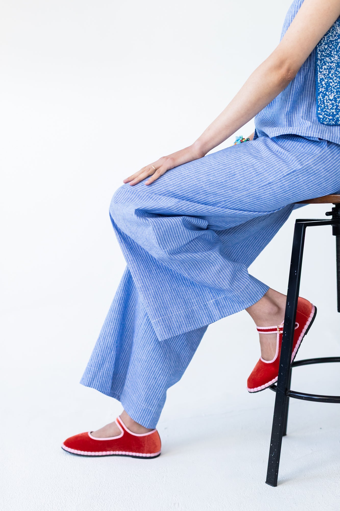 Sydney wide leg stripe pants, close up seated view showing wide leg drape