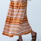 Sorrento Sunset Stripe skirt, close-up side view showing pleats and pocket