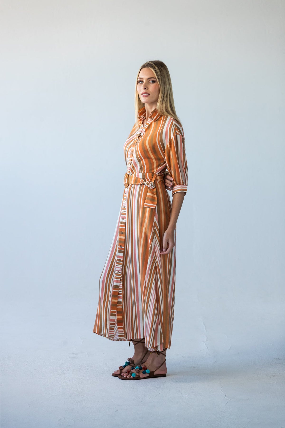 Cassidy Sunset Stripe dress, side profile, full length, hand in pocket