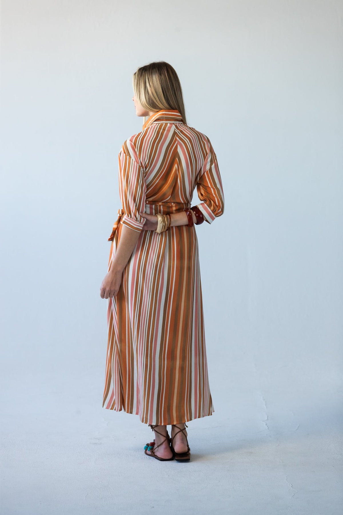 Cassidy Sunset Stripe dress, back view showing vertical stripe and tied belt