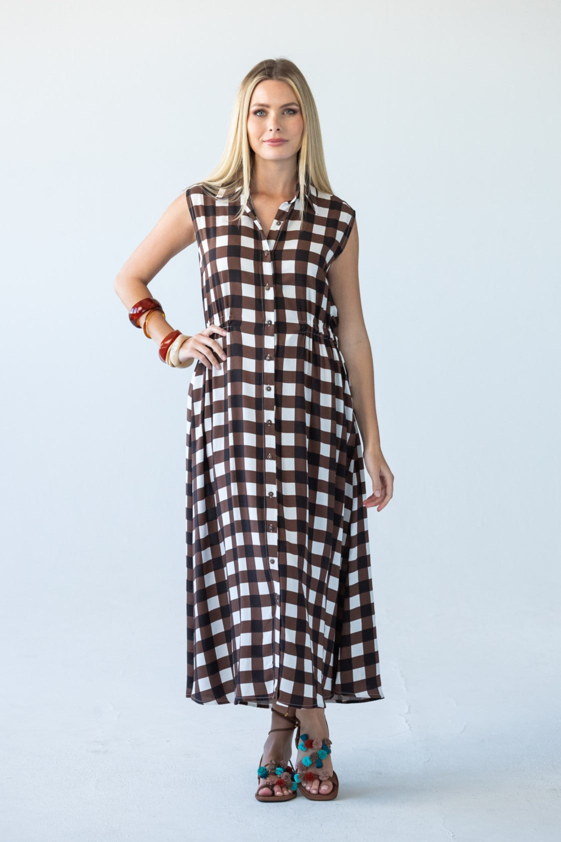 Sutton sleeveless shirt-dress in chocolate check, full-length front view with hand on hip