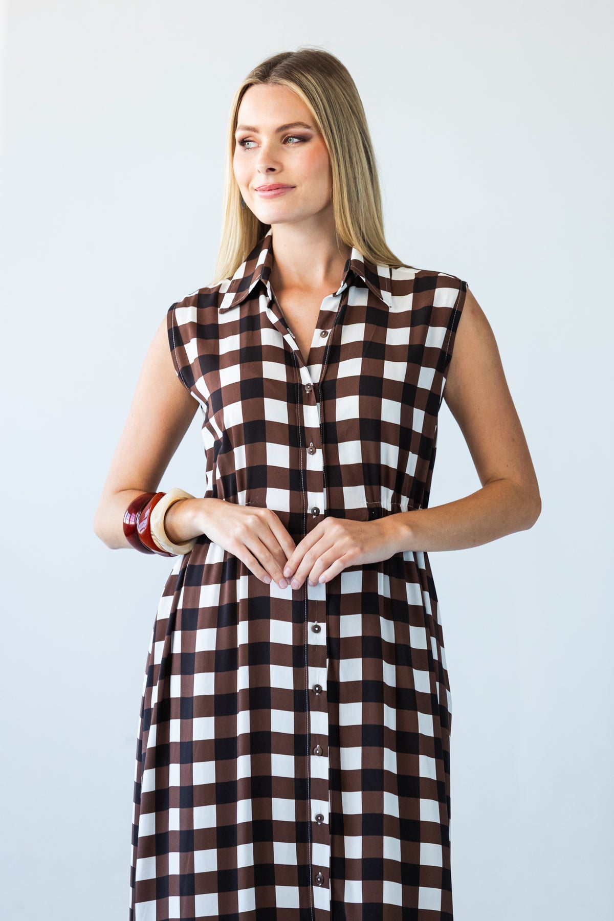 Sutton chocolate check shirt-dress, front view with hands clasped at the waist