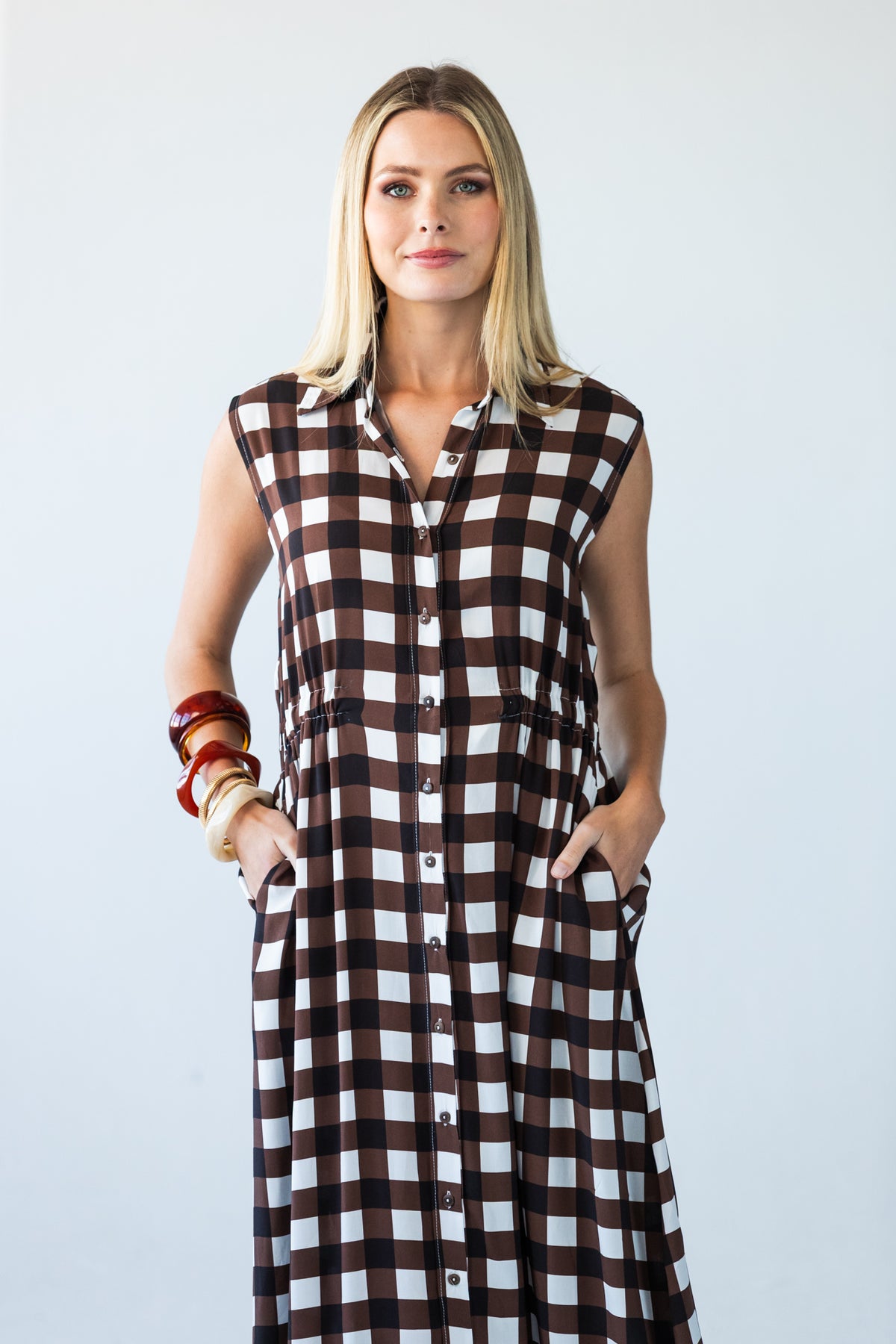 Sutton chocolate check shirt-dress, front view with hands in side pockets