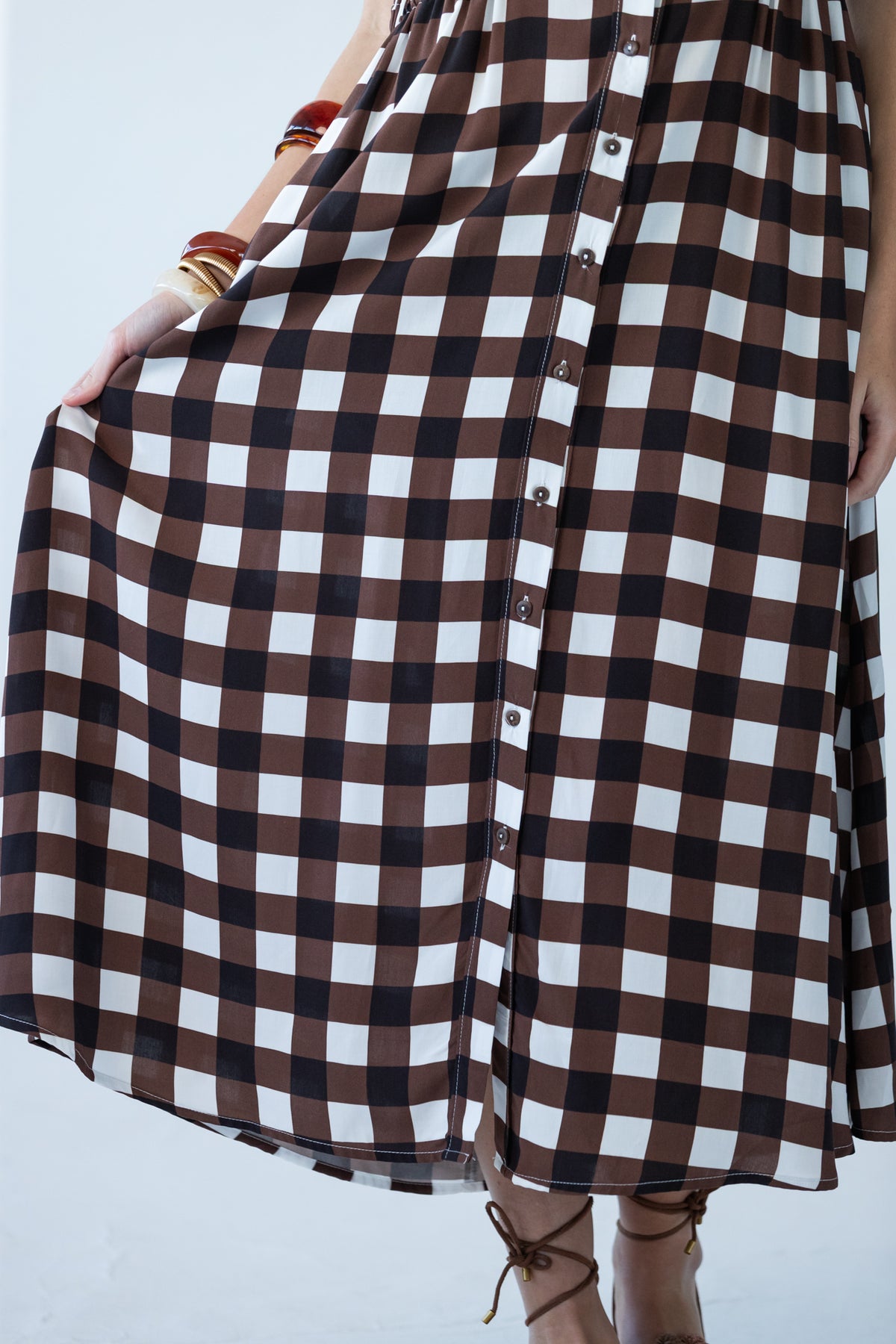 Sutton chocolate check shirt-dress, skirt held out showing midi length and button placket