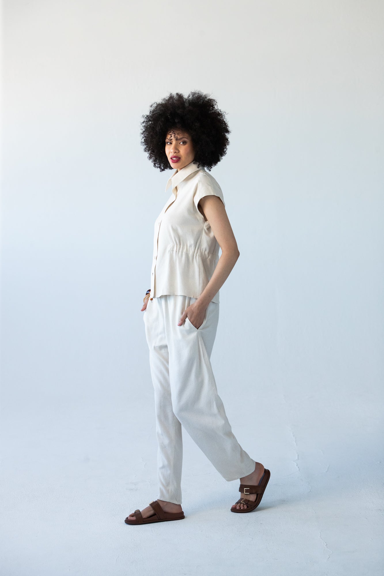 Reese stone shirt, side view walking, styled with matching trousers