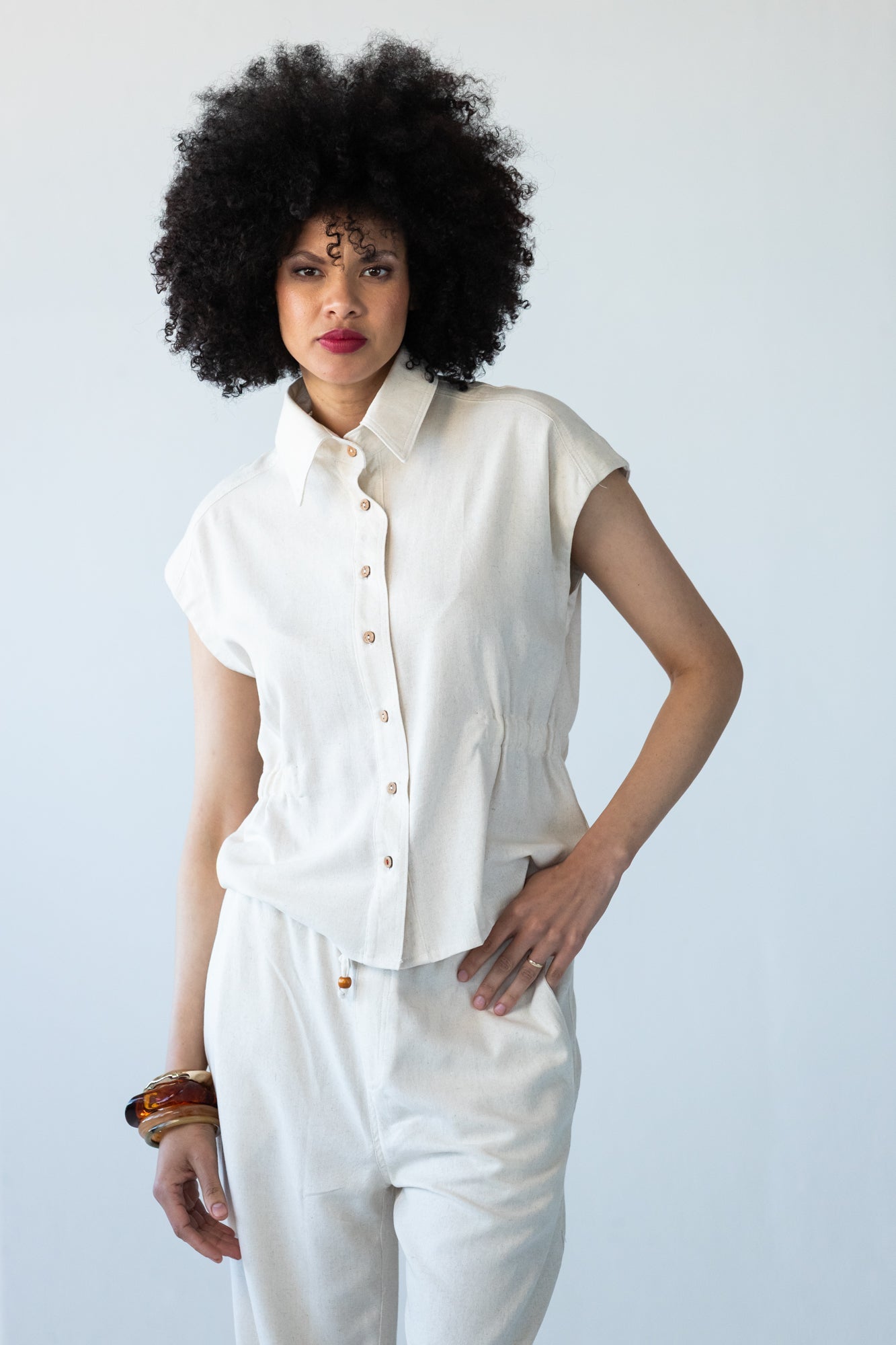 Reese stone shirt, front view with hand on hip